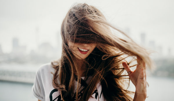 Woman with hair blown across her face on a windy day